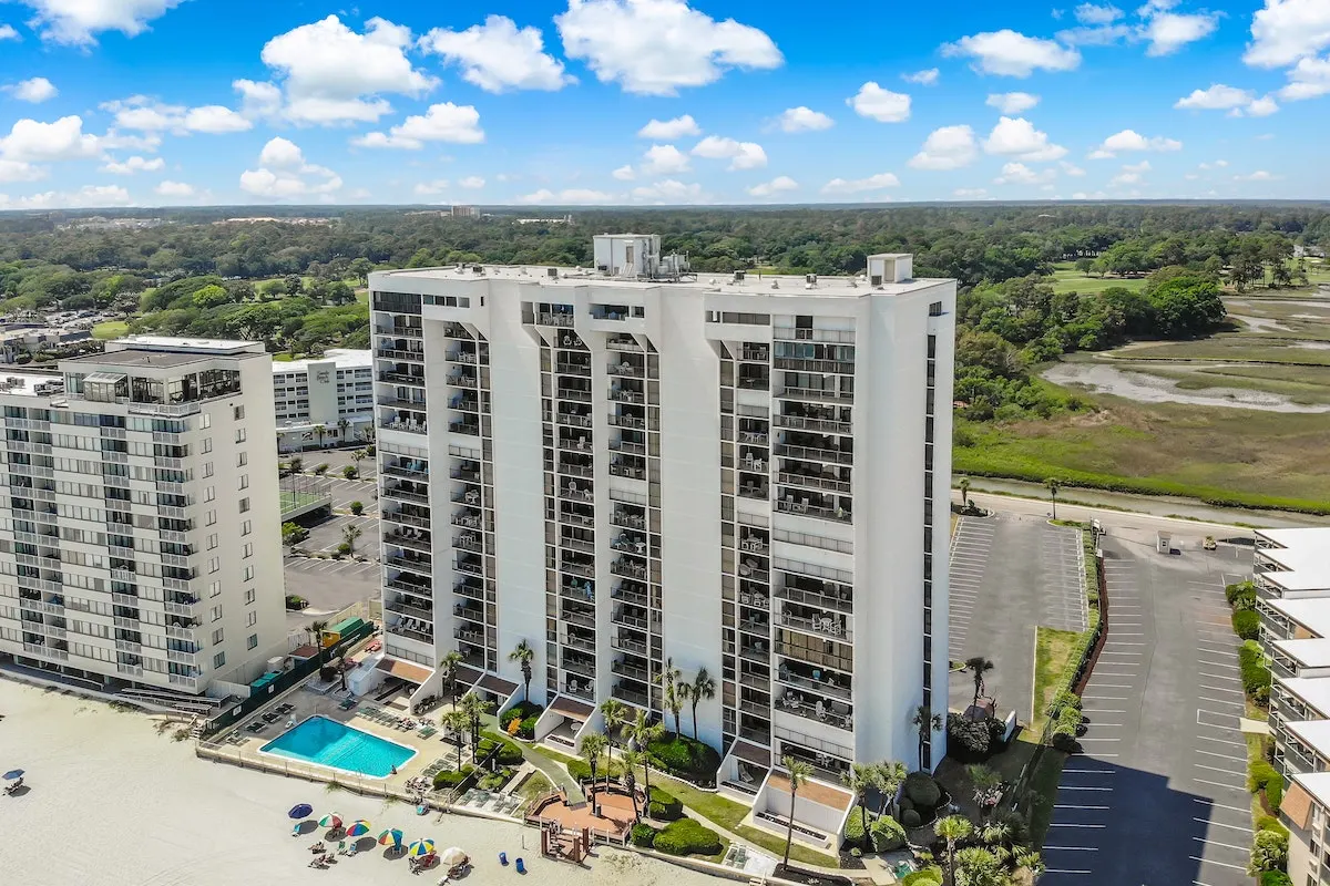 Brigadune condominiums from the air, with the beach in front