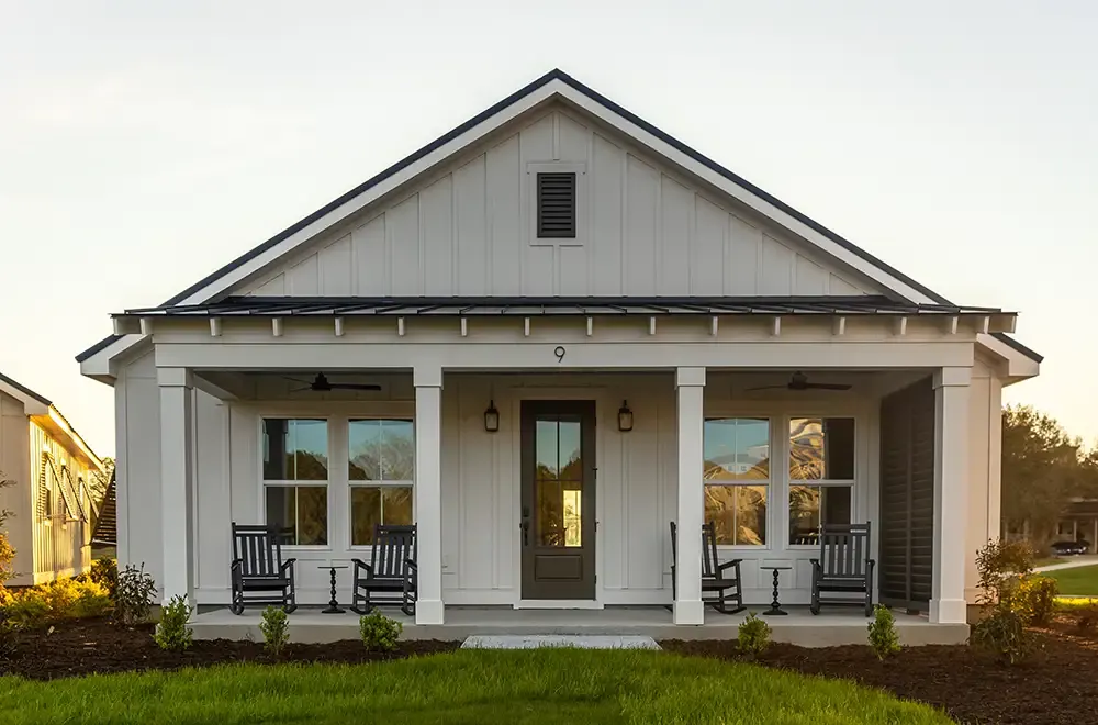 A Dye Club Cottage with its front porch at dusk